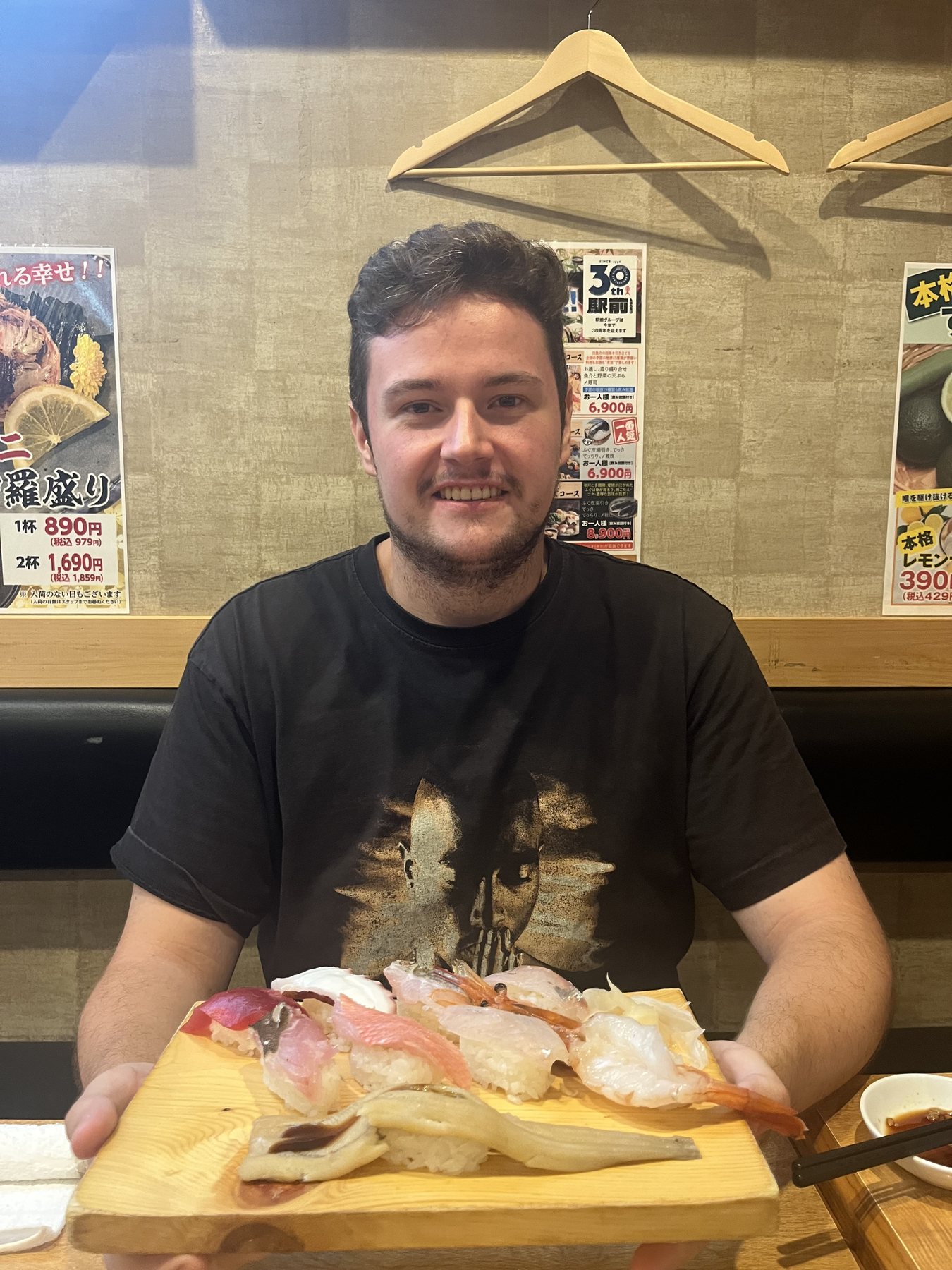 A guest enjoying a generous sushi dinner in Kobe