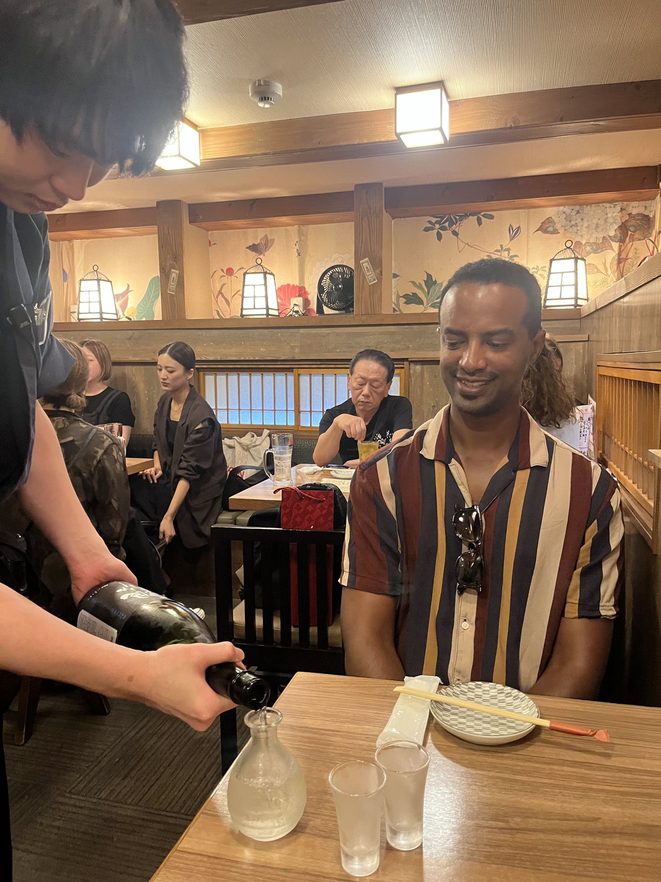 Guest tasting sake at dinner