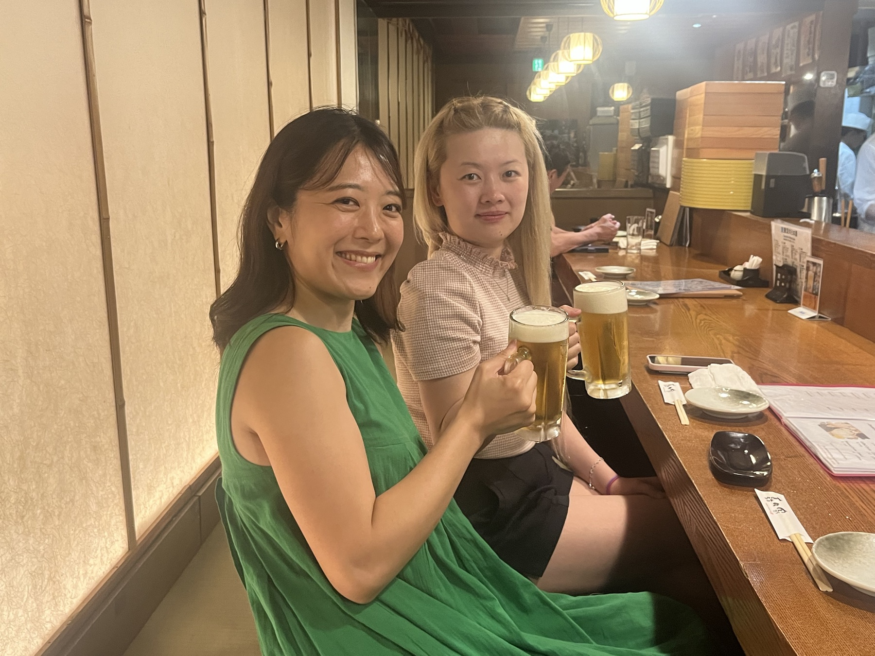 Aki and a private tour guest raising beer glasses at a local Osaka restaurant