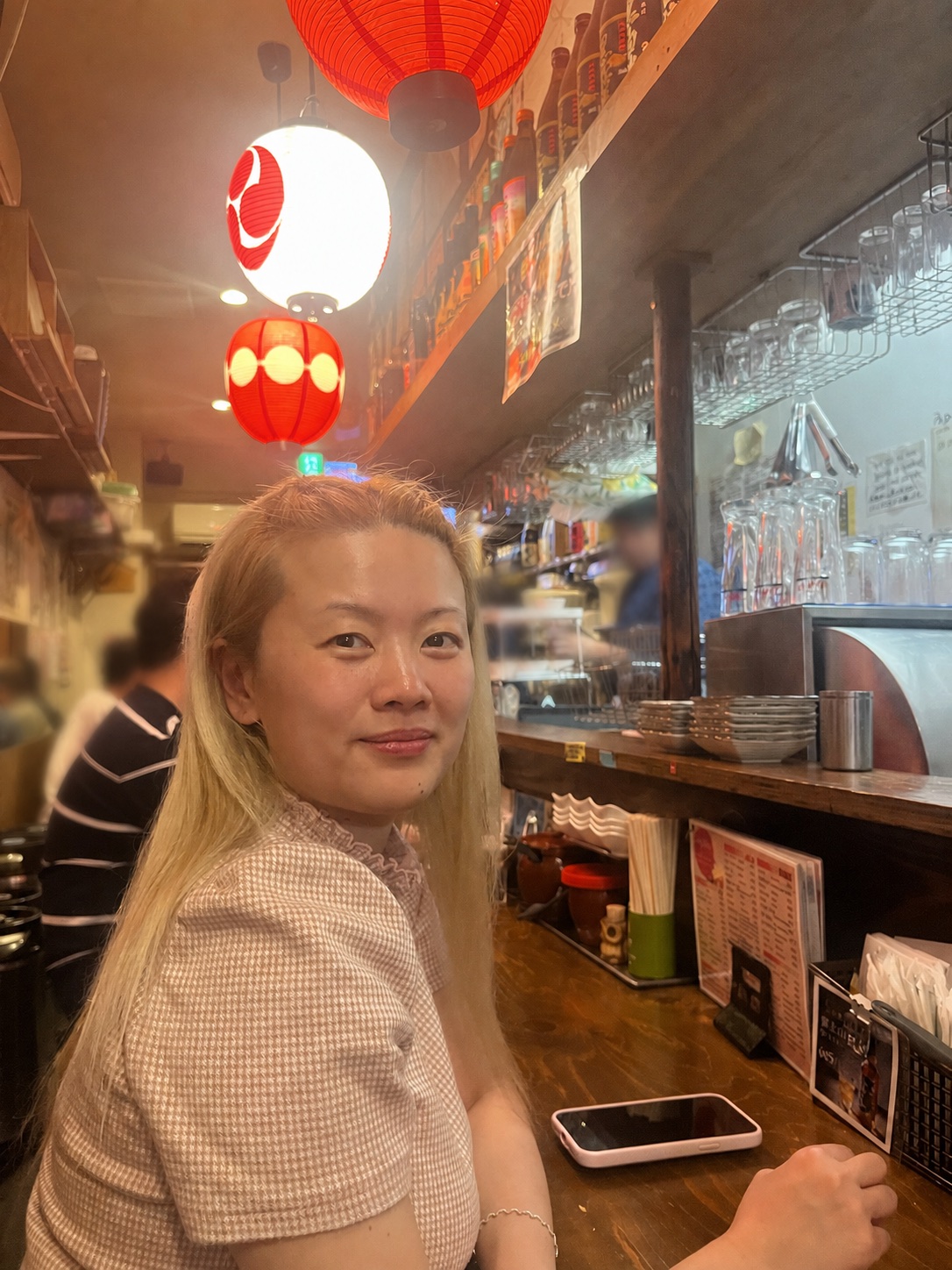 A private tour guest enjoying the atmosphere at a local Osaka counter restaurant
